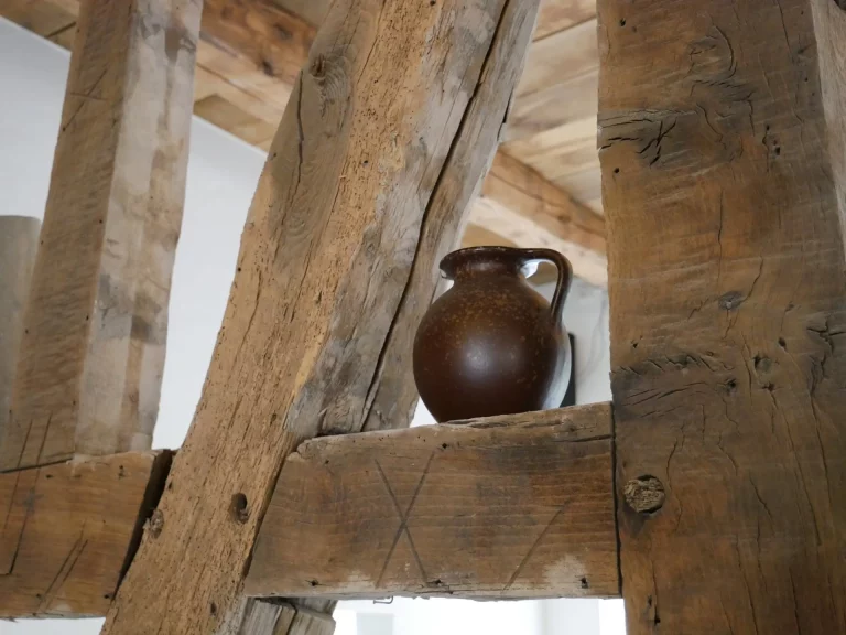 Detailbild: Krug steht auf den alten Holzbalken